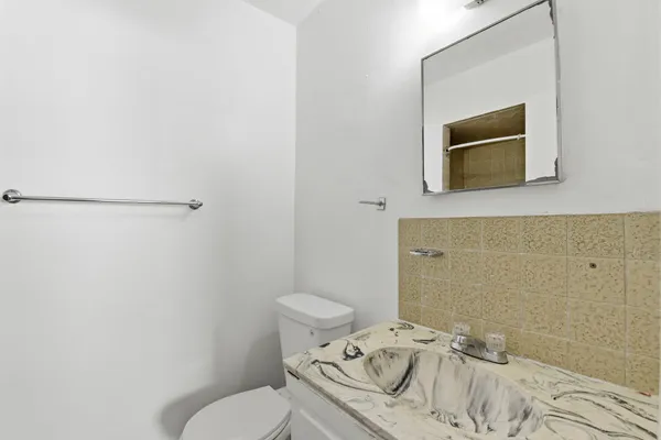 a bathroom with a toilet sink and tub