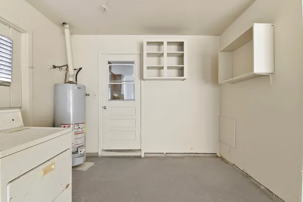 an empty room with a cabinet and mirrors