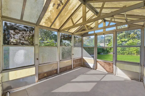 a view of a yard in front of a house with a large tree