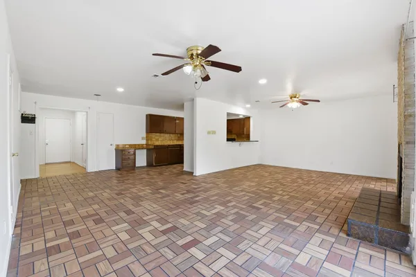 a view of an empty room with window and fireplace