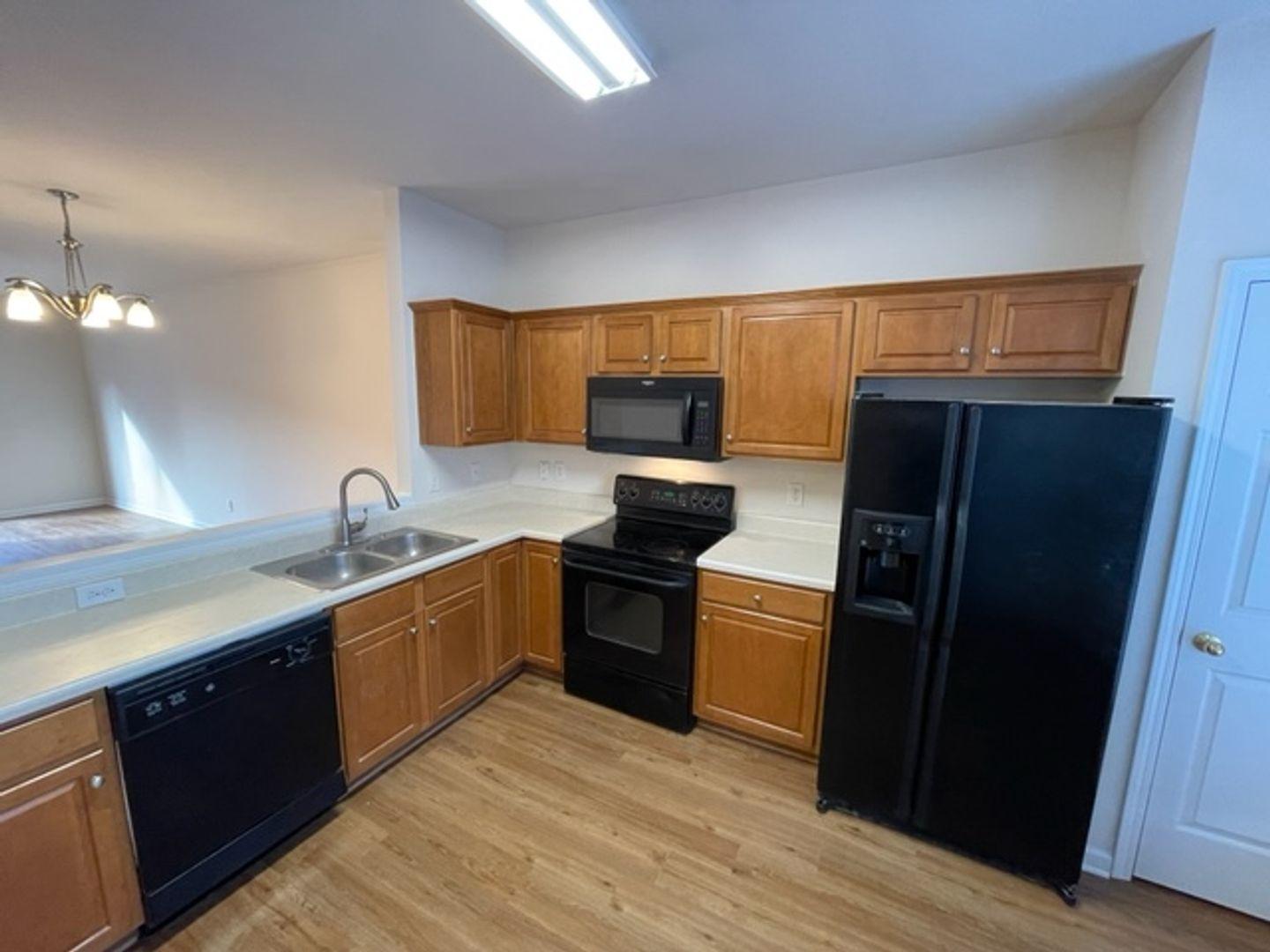 1672 Brook Fern Way Raleigh, NC 27609 - Photo 5 of 14 a kitchen with granite countertop stainless steel appliances and wooden cabinets