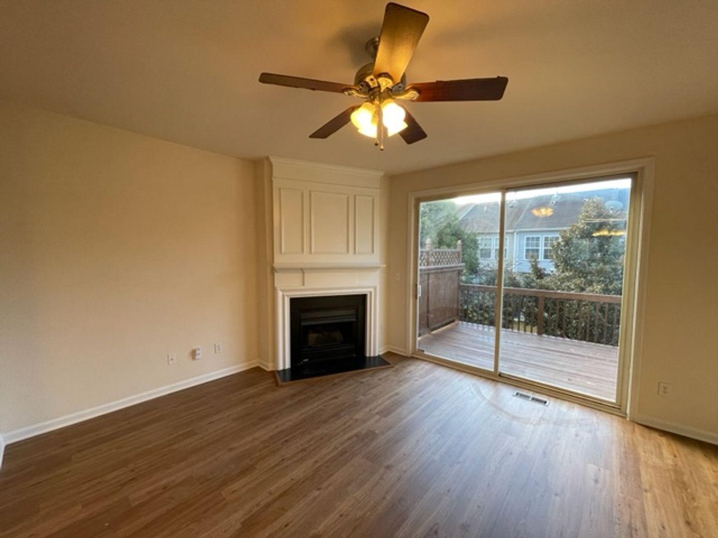 1672 Brook Fern Way Raleigh, NC 27609 - Photo 8 of 14 a view of empty room with wooden floor and fan