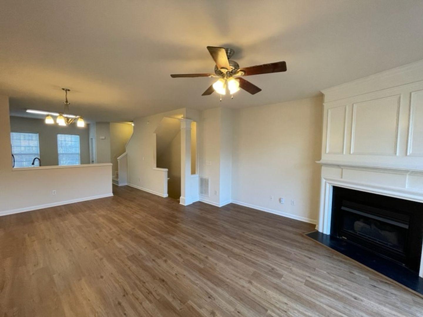 1672 Brook Fern Way Raleigh, NC 27609 - Photo 9 of 14 a view of an empty room with wooden floor and a fireplace