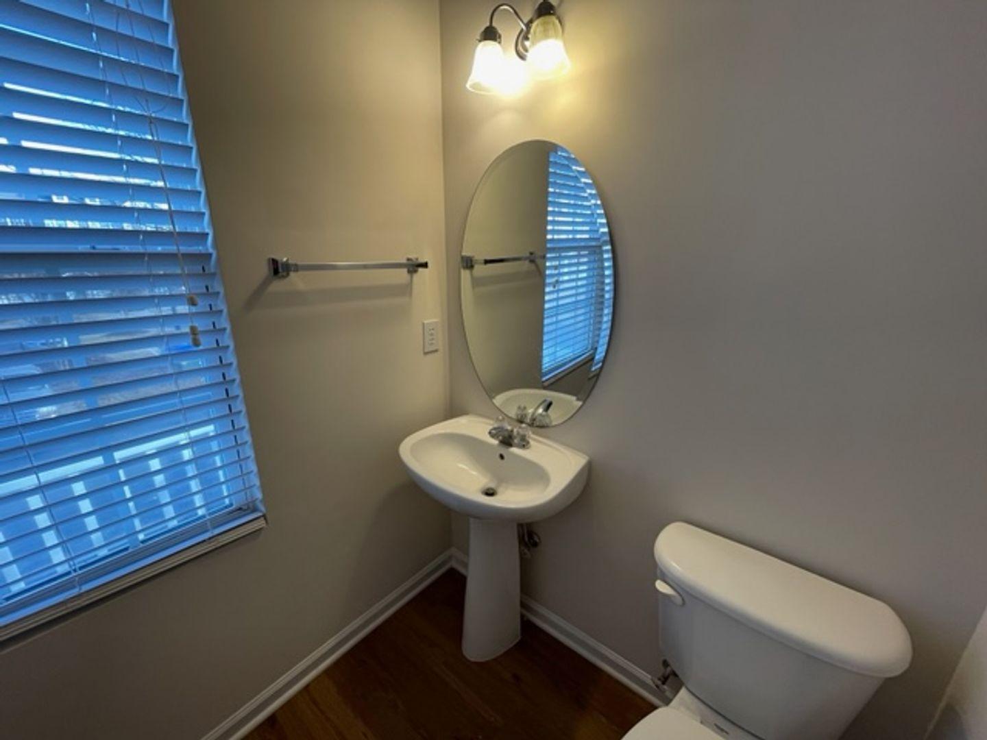 1672 Brook Fern Way Raleigh, NC 27609 - Photo 10 of 14 a bathroom with a toilet sink and mirror