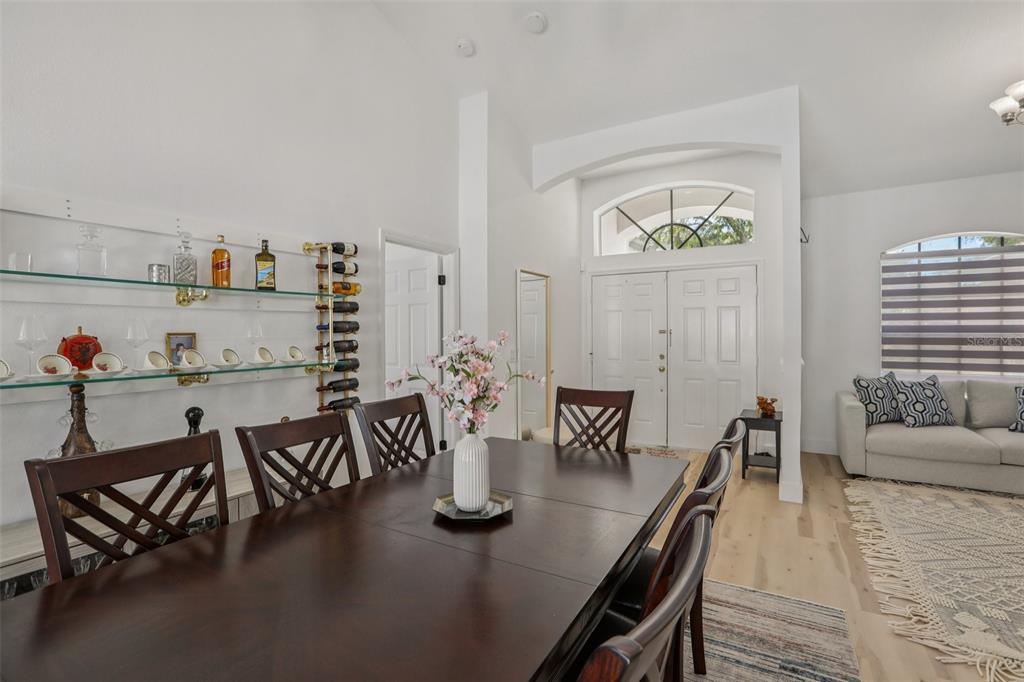 1524 Stipule Court Trinity, FL 34655 - Photo 14 of 43 a dining room with furniture and wooden floor