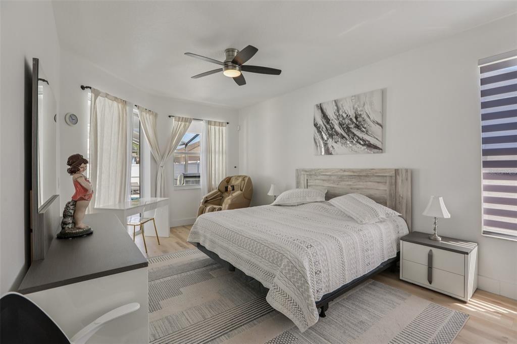 1524 Stipule Court Trinity, FL 34655 - Photo 20 of 43 a bedroom with a bed and a chandelier