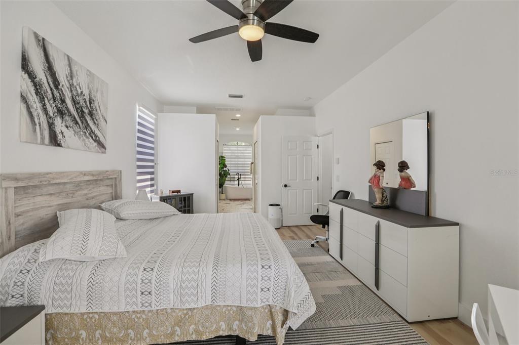 1524 Stipule Court Trinity, FL 34655 - Photo 21 of 43 a bedroom with a bed and ceiling fan