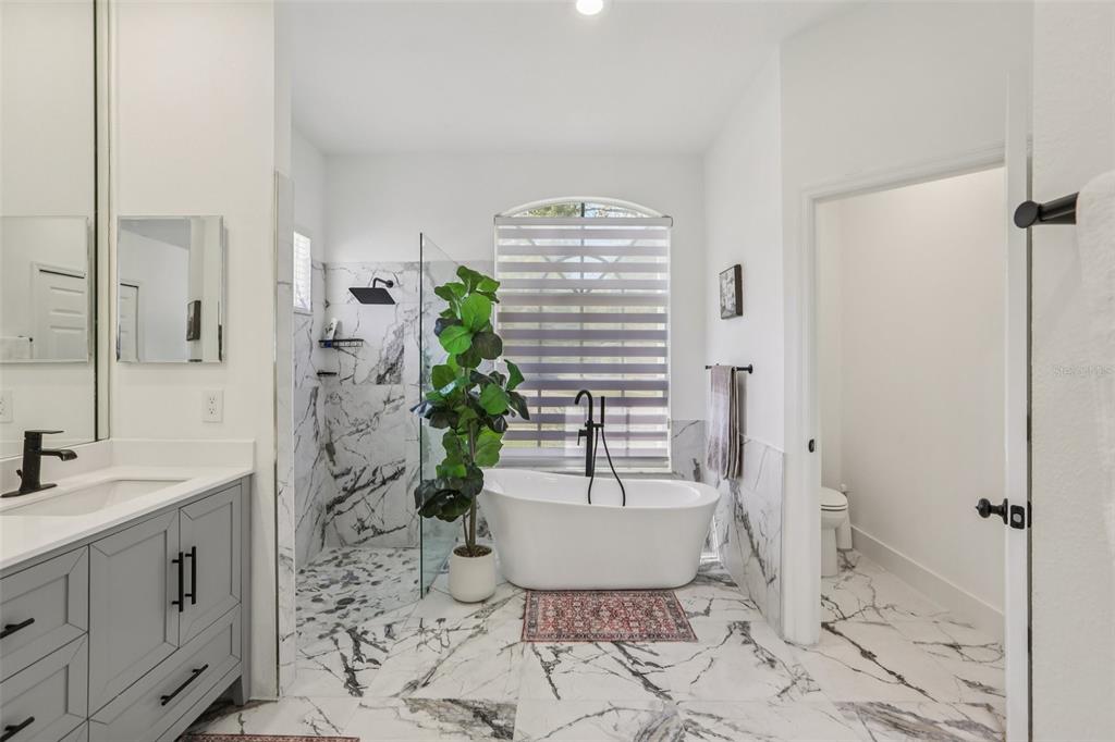 1524 Stipule Court Trinity, FL 34655 - Photo 23 of 43 a bathroom with a bathtub and shower