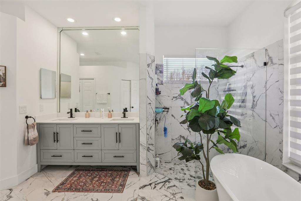 1524 Stipule Court Trinity, FL 34655 - Photo 24 of 43 a bathroom with a granite countertop shower a sink and a mirror