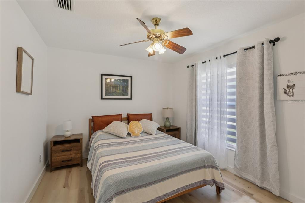 1524 Stipule Court Trinity, FL 34655 - Photo 32 of 43 a bedroom with a bed and a chandelier