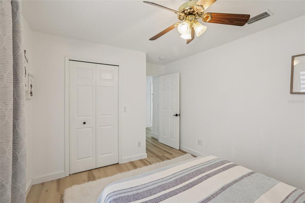 1524 Stipule Court Trinity, FL 34655 - Photo 33 of 43 a bedroom with a bed and a chandelier fan