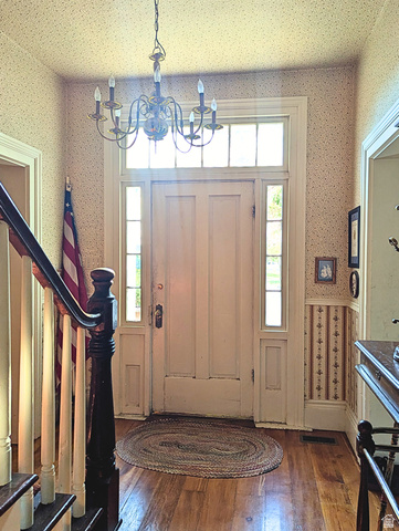 190 North 200 E Street Beaver, UT 84713 - Photo 20 of 40 Entryway featuring a paneled door, transom window, side lights, hardwood flooring, and a chandelier