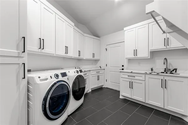 a utility room with sink dryer and washer