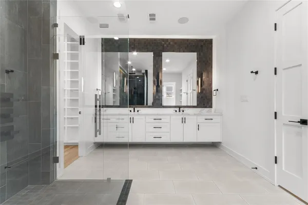 a bathroom with a double vanity sink and mirror