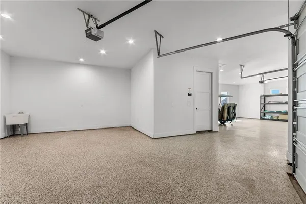 a view of a livingroom with a refrigerator and cabinets