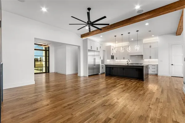 a view of kitchen and hall with wooden floor