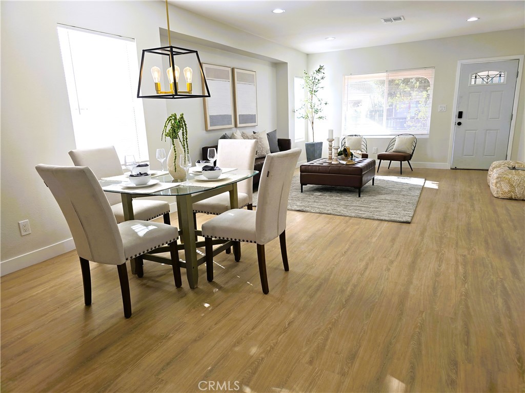 a view of a dining room with furniture window and wooden floor