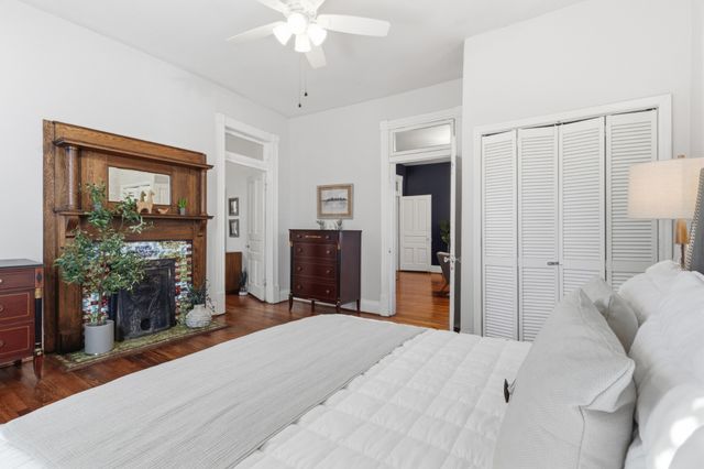 a bedroom with a bed and a chandelier