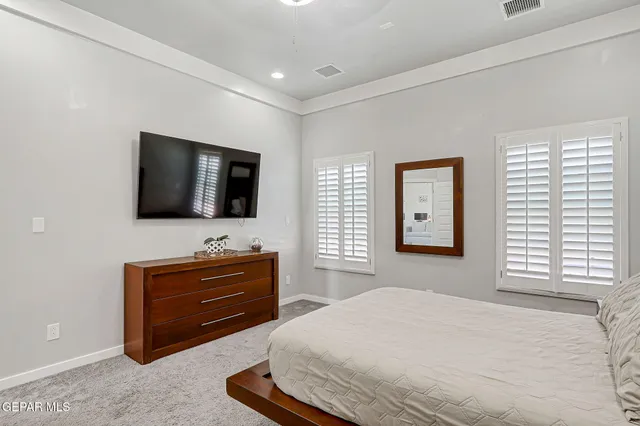 a bedroom with a bed and cabinets