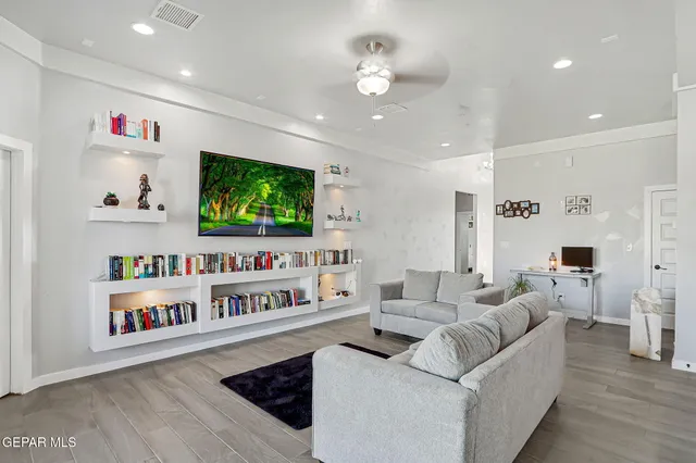 a living room with furniture and a flat screen tv