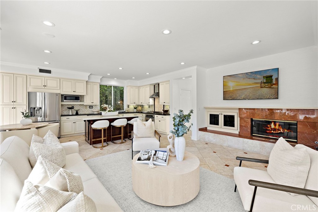 18 Bel Spring Irvine, CA 92602 - Photo 13 of 44 a living room with fireplace furniture and a kitchen view
