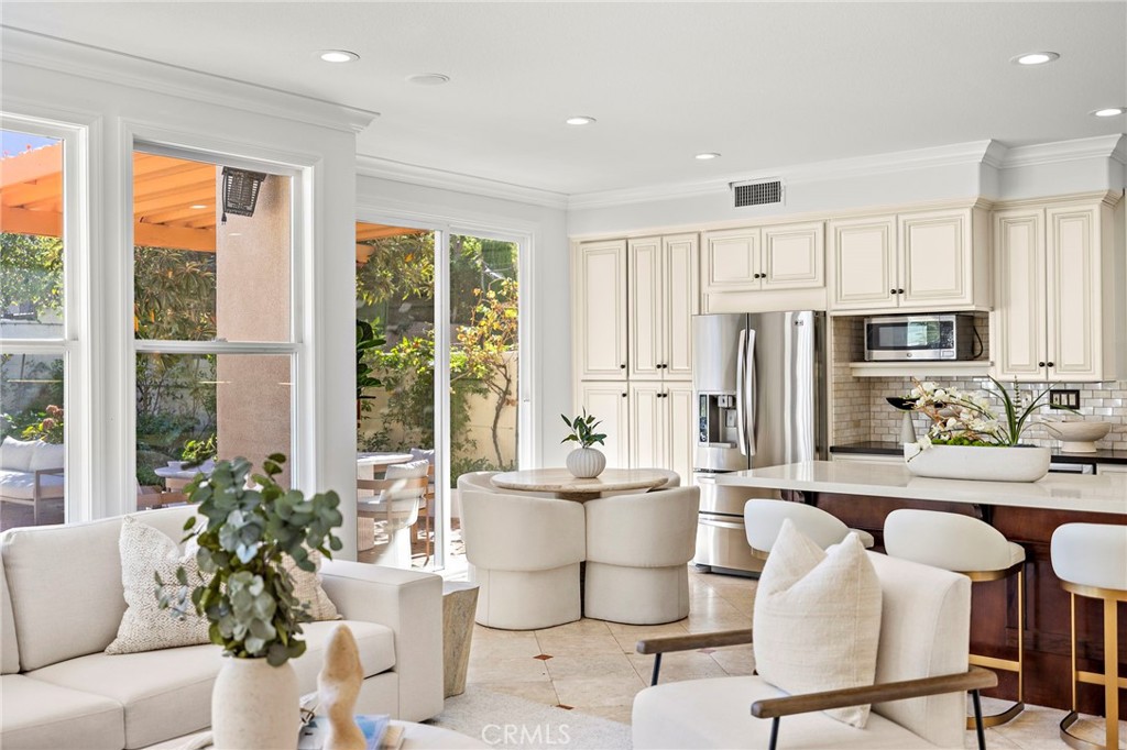 18 Bel Spring Irvine, CA 92602 - Photo 18 of 44 a living room with stainless steel appliances furniture a large window and a dining table