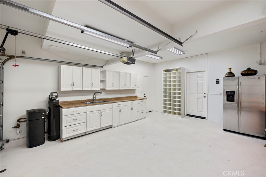 18 Bel Spring Irvine, CA 92602 - Photo 32 of 44 a large white kitchen with a refrigerator a sink and dishwasher