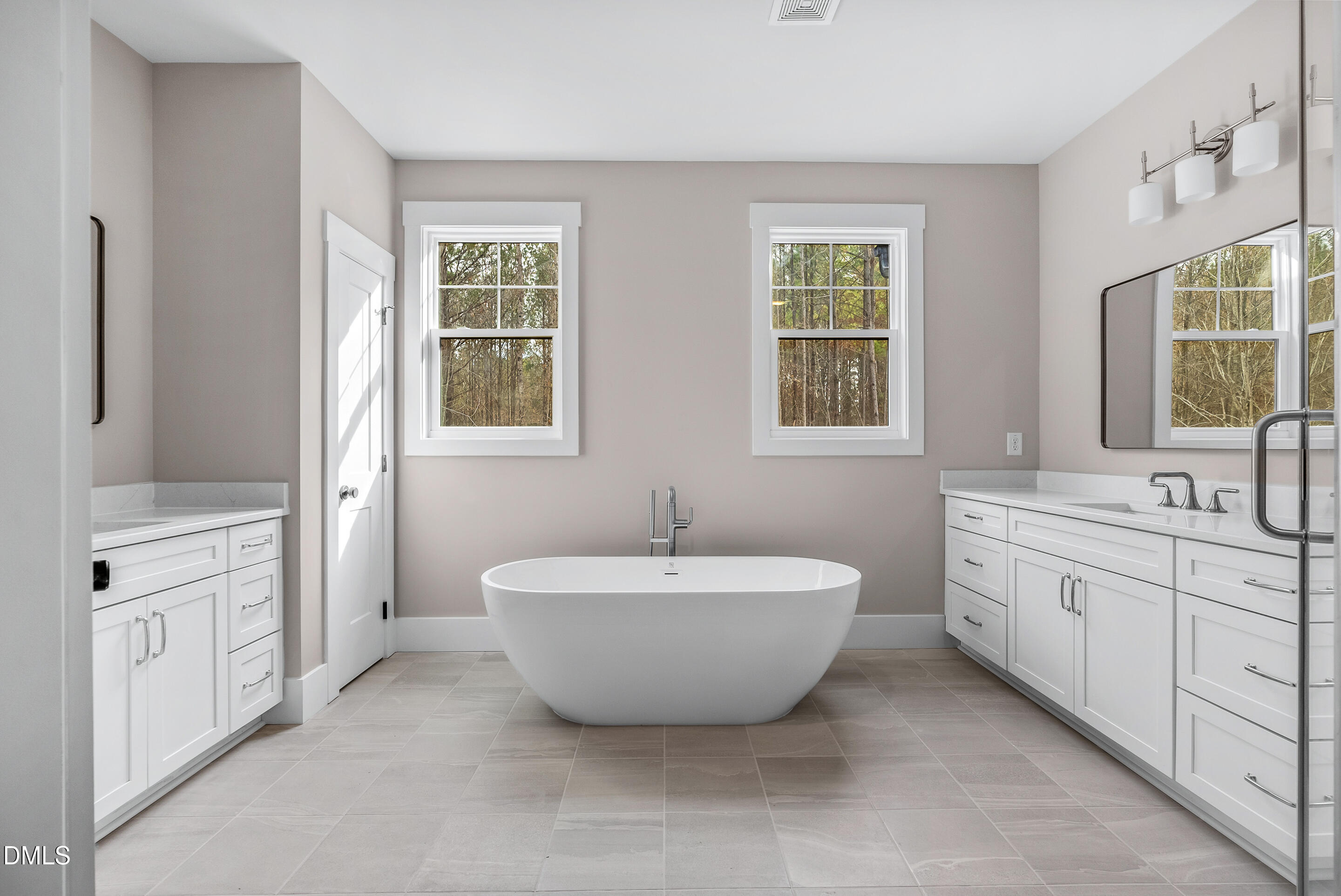 1200 Lake Wendell Road Wendell, NC 27591 - Photo 6 of 11 a spacious bathroom with double vanity sink a two mirror a window a bathtub and vanity