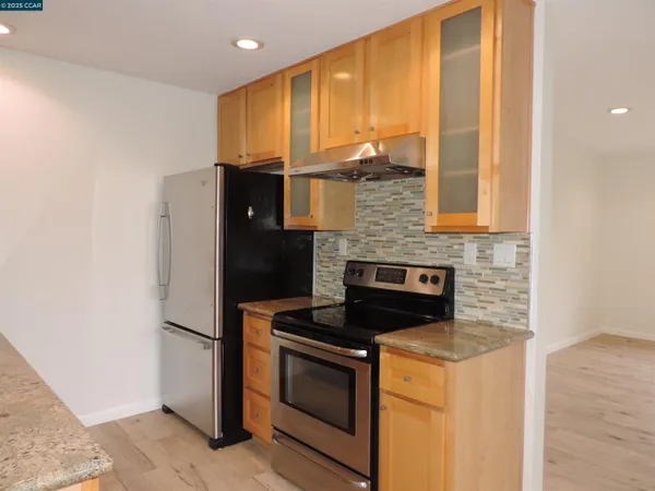 a kitchen with stainless steel appliances a refrigerator and a stove