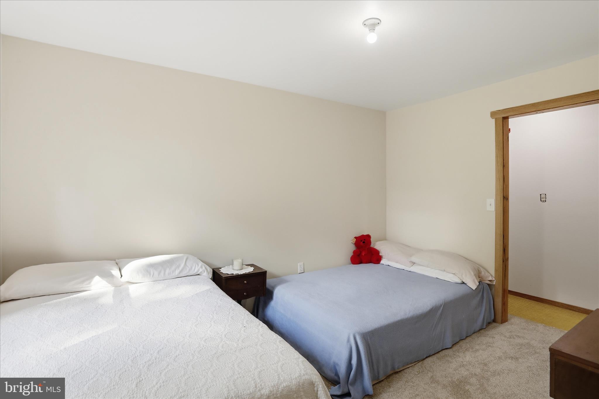 936 Johnny Cake Road Great Cacapon, WV 25422 - Photo 23 of 33 a bedroom with two bed and a wooden floor