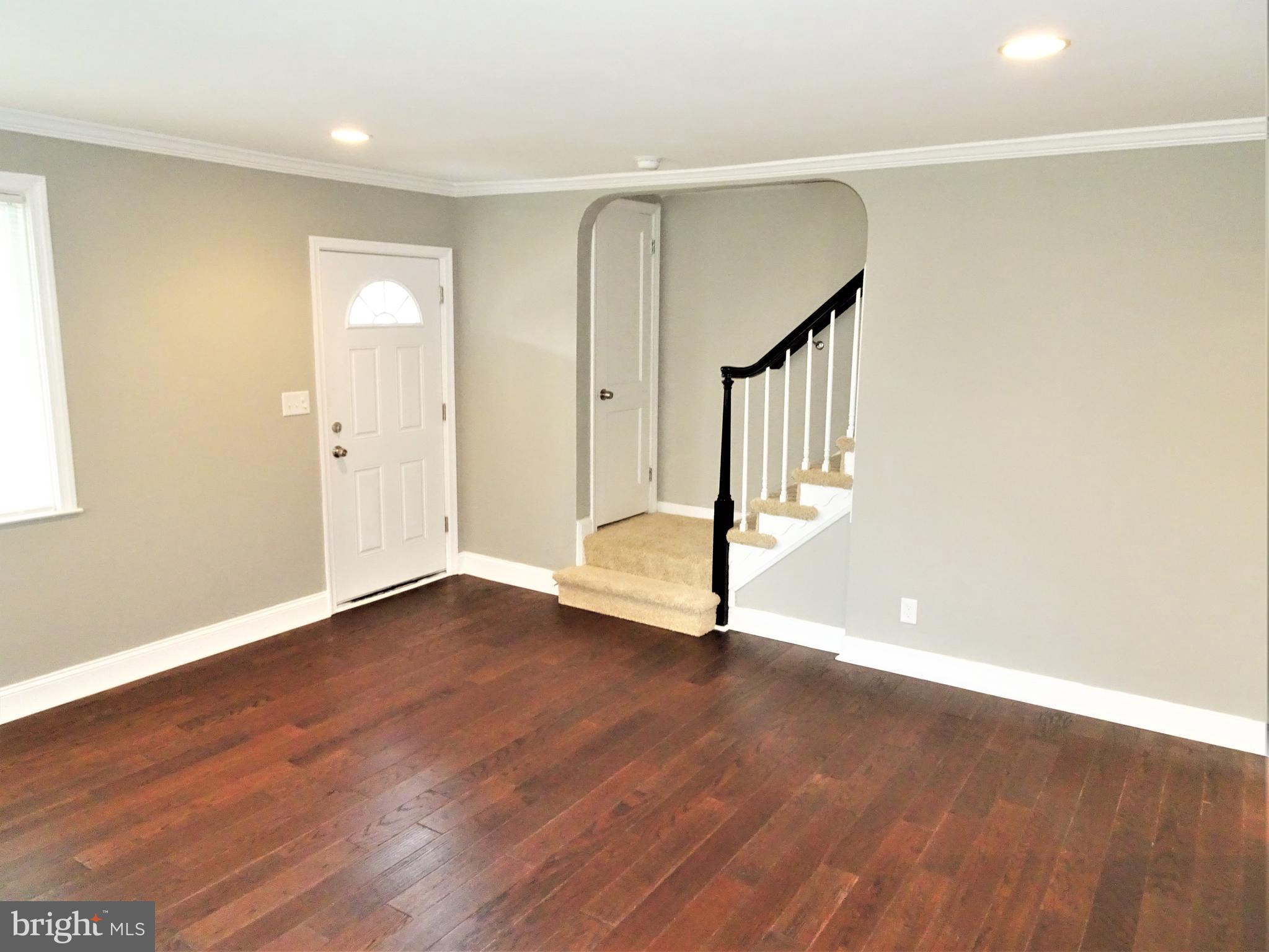 1216 Glenhaven Road Baltimore, MD 21239 - Photo 13 of 45 Living room crown molding & 5 1/4" baseboard