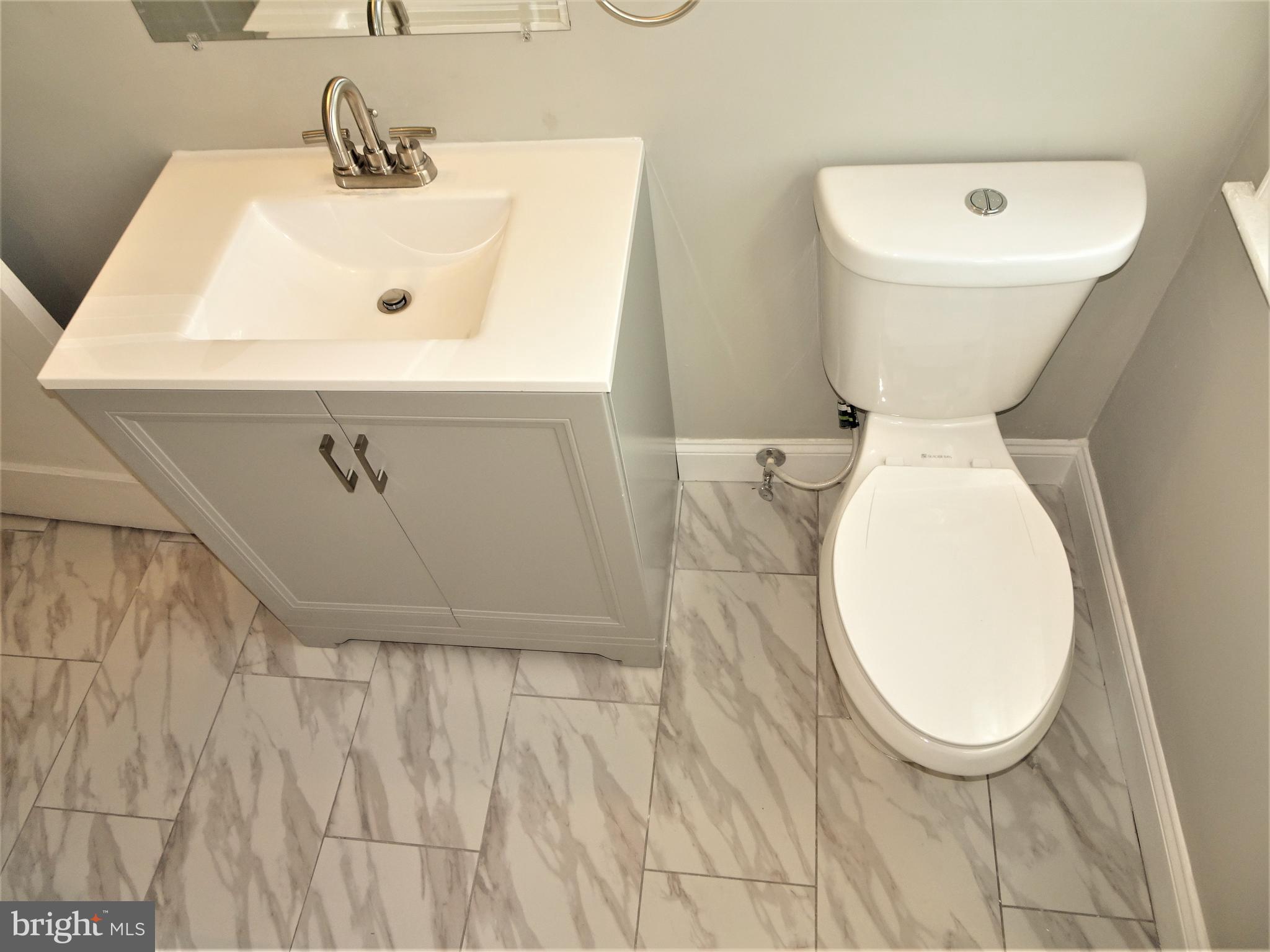 1216 Glenhaven Road Baltimore, MD 21239 - Photo 20 of 45 30" vanity , dual flush toilet and ceramic tile