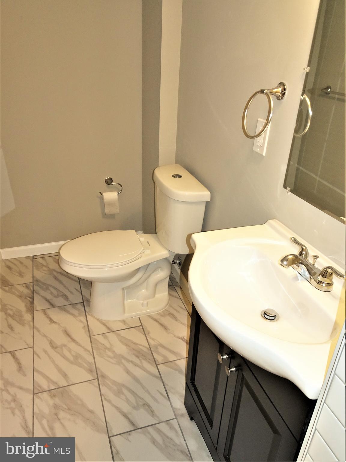 1216 Glenhaven Road Baltimore, MD 21239 - Photo 31 of 45 Dual flush toilets w/ subway & ceramic tile