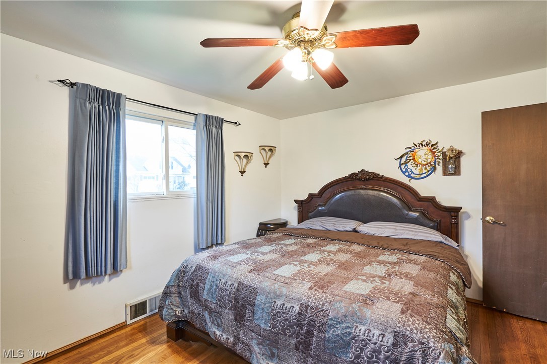 15813 Wingate Road Maple Heights, OH 44137 - Photo 15 of 26 Bedroom featuring visible vents, a ceiling fan, and wood finished floors