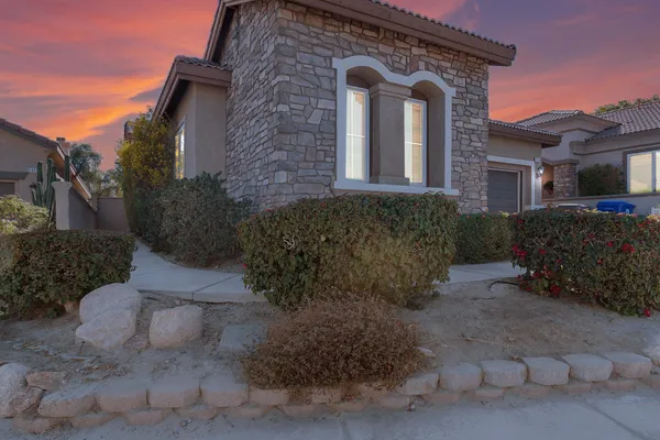 a front view of a house with garden