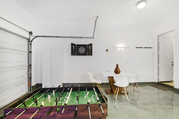 a room with chairs and rug