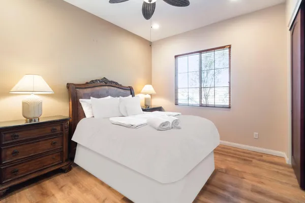 a bedroom with a bed and a night stand