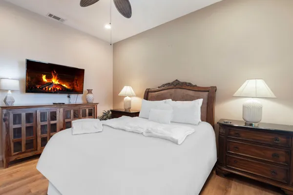 a kitchen with stainless steel appliances kitchen island granite countertop a table chairs and a refrigerator