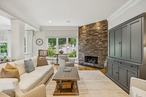 a kitchen with stainless steel appliances granite countertop a table chairs and a wooden floor