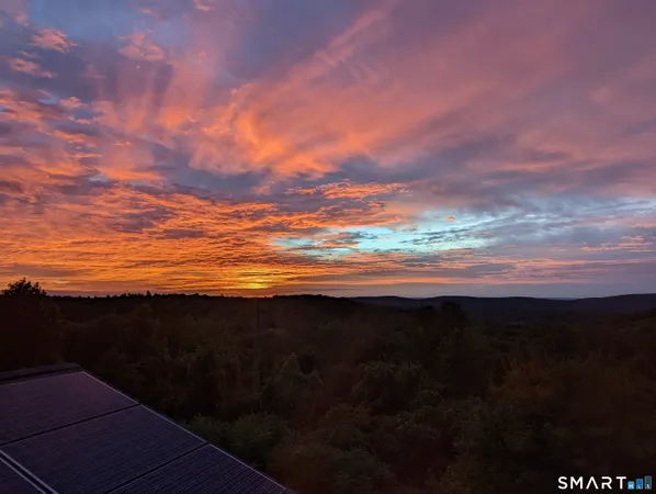 a dining room with furniture a chandelier and window