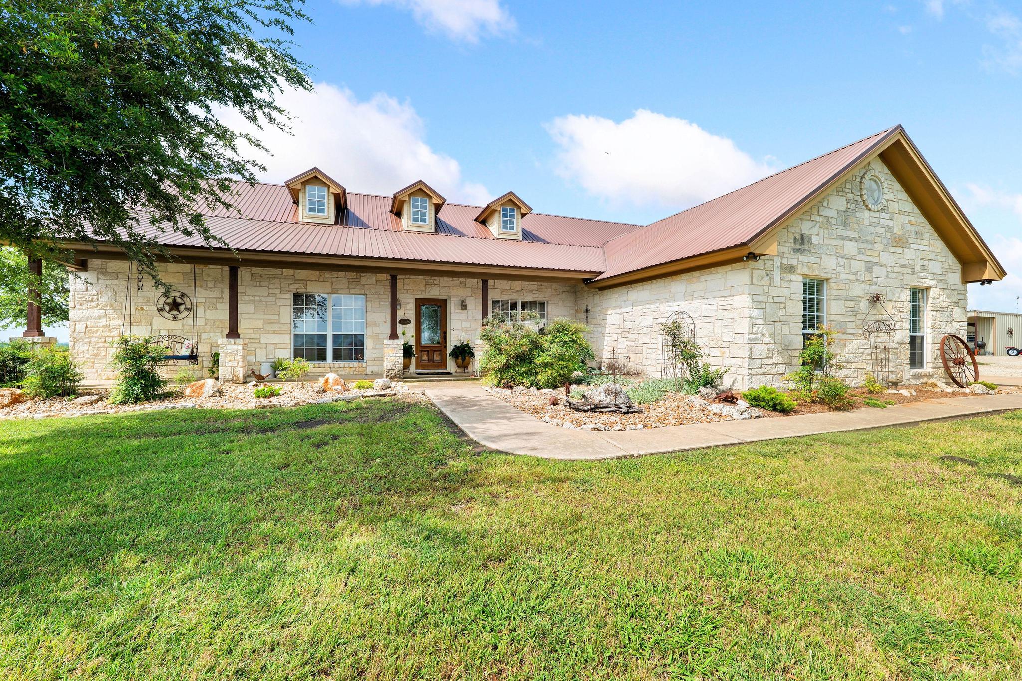 19000 Farm To Market Road 971 Granger, TX 76530 - Photo 6 of 40 The charming home is adorned with beautiful stone.