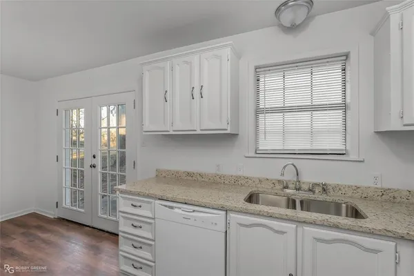 a kitchen with appliances cabinets and a sink