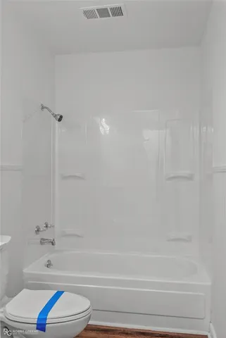 a bathroom with a bathtub and a toilet