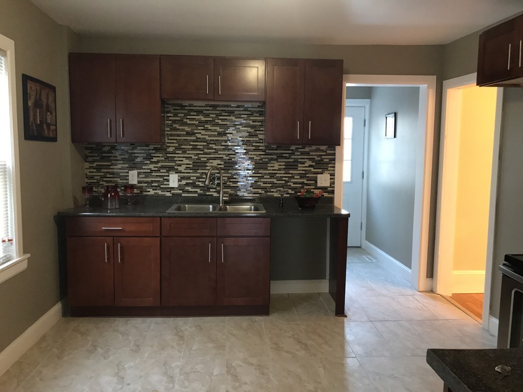 97 Penacook Street Springfield, MA 01104 - Photo 3 of 11 a kitchen with stainless steel appliances granite countertop wooden cabinets and a granite counter tops