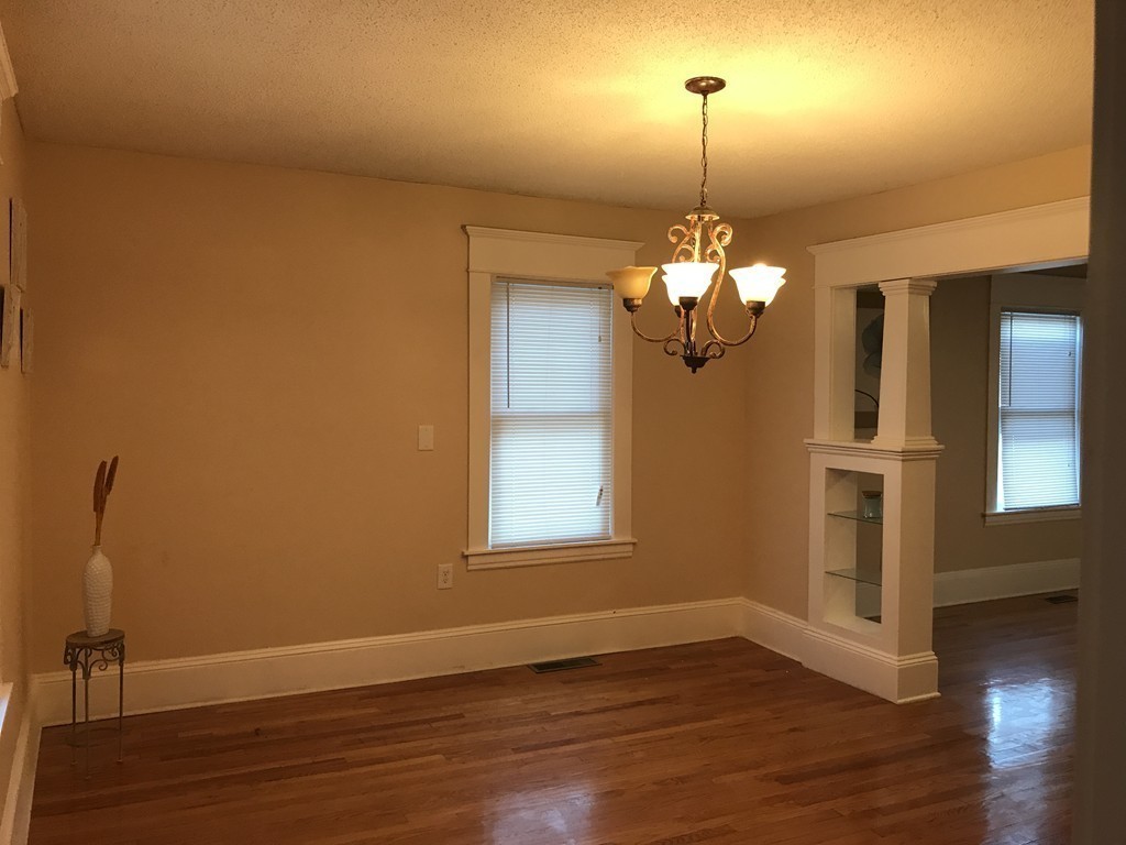 97 Penacook Street Springfield, MA 01104 - Photo 7 of 11 a view of a room with wooden floor chandelier and window