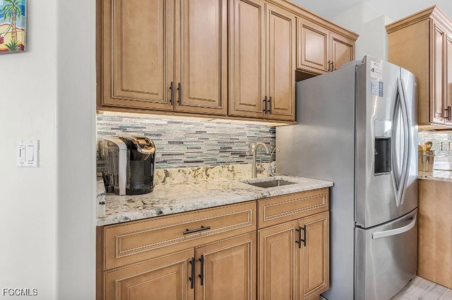 4885 East Riverside Drive Fort Myers, FL 33905 - Photo 13 of 45 a kitchen with stainless steel appliances granite countertop a refrigerator a sink and white cabinets