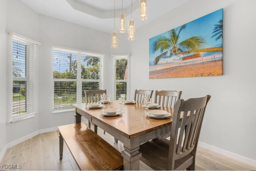 4885 East Riverside Drive Fort Myers, FL 33905 - Photo 14 of 45 a view of a dining room with furniture large window and outside view
