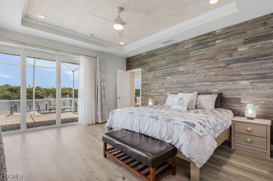 4885 East Riverside Drive Fort Myers, FL 33905 - Photo 17 of 45 a bedroom with a bed wooden floor and large window