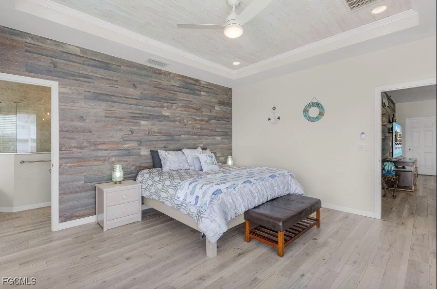 4885 East Riverside Drive Fort Myers, FL 33905 - Photo 18 of 45 a bedroom with a bed and a table with wooden floor