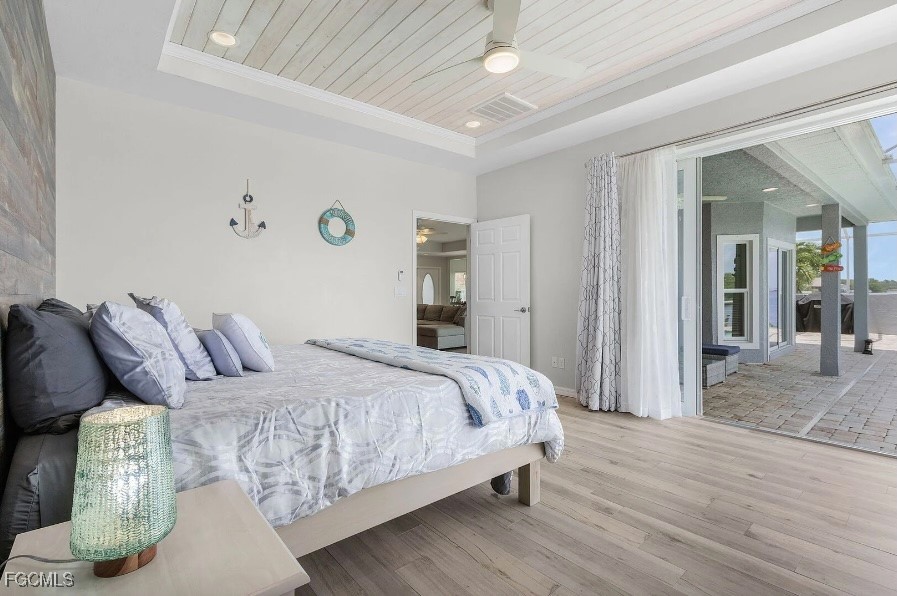 4885 East Riverside Drive Fort Myers, FL 33905 - Photo 19 of 45 a bedroom with a bed and a chandelier